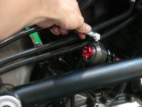 Route the hose along the frame as shown. You can use tie wrap to secure it.