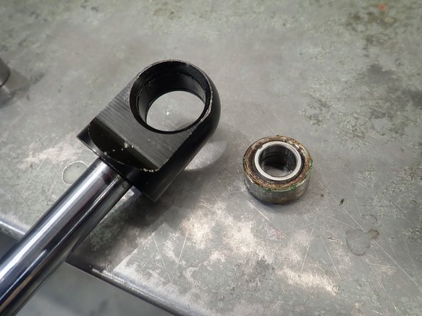 Press out the bearing and clean shock's end bore if necessary.