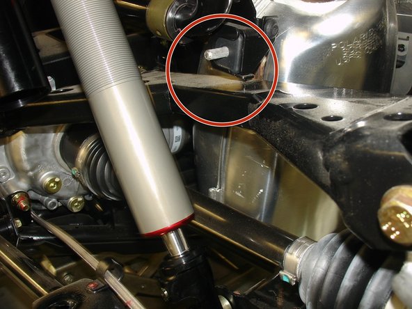 IMPORTANT NOTE:  The rear shocks for this vehicle model are equipped with 15mm stroke limiters to restrict the wheel travel and prevent contact between the exhaust bracket and the right rear a-arm under full compression of the suspension (see red circle on photo 2).