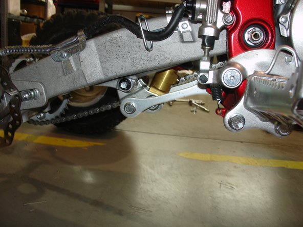 Install the linkage and put the rebound adjuster (adjustable using a screwdriver) at the bottom of the shock should face the front of the quad.