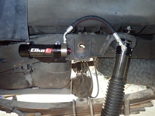 Place left reservoir into holding clamps, and torque bolts at 12 foot/pounds.