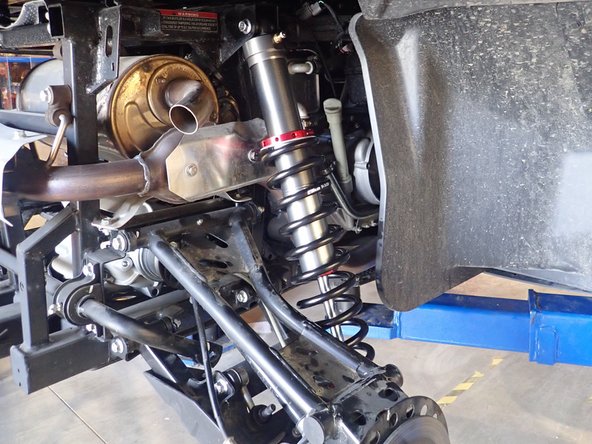 On Stage 2, Stage 4, and Stage 5 models the rebound adjuster located on lower eyelet of the shocks should be oriented towards the front of the vehicle, as shown. (Left side shown ). If needed, you can turn the lower eyelet to orient properly.