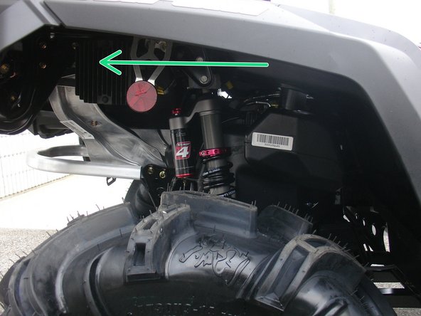 Install the right new Elka rear shock with the piggyback reservoir at the top and oriented towards the rear of the vehicle as indicated by the green Arrow on the photo.