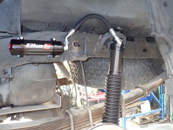 Tighten upper and lower shock bolts.