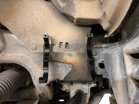 Install reservoir as shown into the holding clamps. Torque the bolts to 10 Ft-Lb.