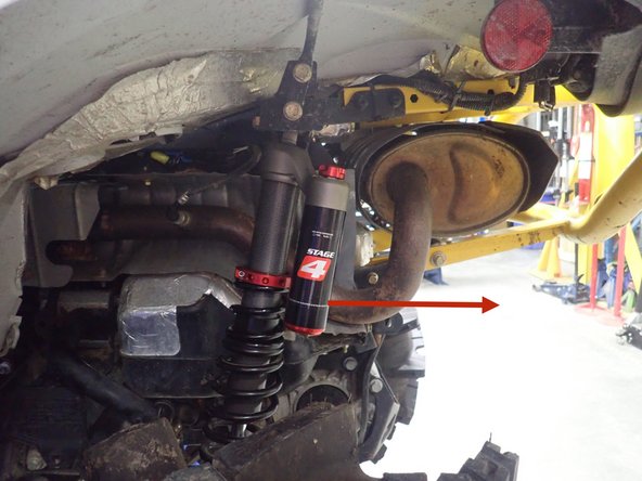 Install the new Elka rear shocks with the piggyback reservoir at the top and oriented towards the rear of the vehicle as indicated by the red Arrow on the photos.