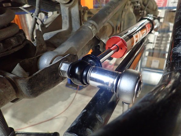 Apply thread locker on shaft threads and torque supplied nut at 70 Lb/Ft.