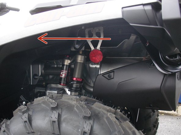 Install the left new Elka rear shock with the piggyback reservoir at the top and oriented towards the front of the vehicle as indicated by the red Arrow on the photo