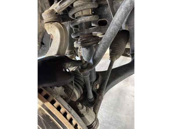 Remove the sway bar link on both sides.