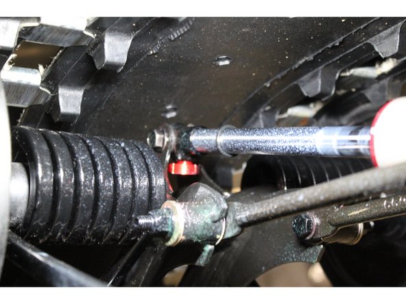 The lower shock eyelets should be installed with the rebound adjuster oriented downwards of the snowmobile.