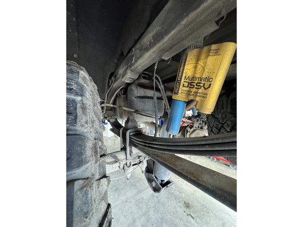 Remove upper and lower bolts from OEM shocks. Keep OEM bolts to install Elka shocks.