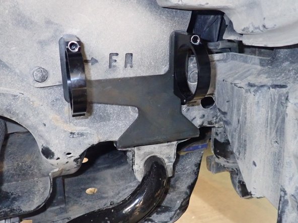 Remove sway bar support bolts, then slide the shock reservoir brackets between support and frame and re-install support bolts in place. (right side shown)