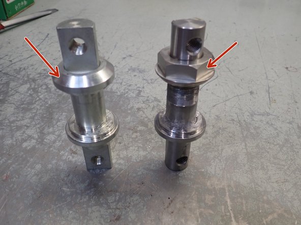 Shock absorber with pins assembly: remove circlip and cap or, on newer design, 32mm nut before pushing pin off of bearing.
