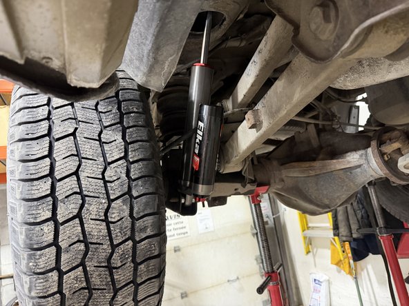 Install new Elka front shocks using lower OEM bolt. (Right side shown)