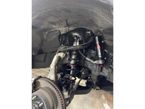 Install the Elka shocks using the oem lower bolts and the provided upper bolts. Hoses must face the front of vehicle as shown (right side shown).