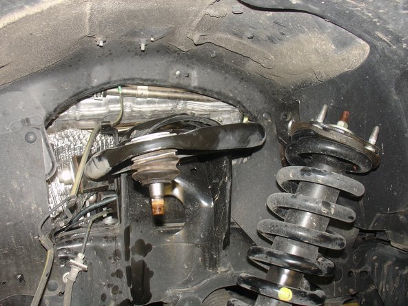 Pull the lower suspension arm down and remove oem shock.