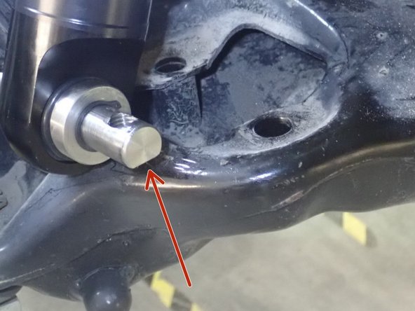 Sit the upper top plate first, then push the lower arm down to bring the lower shock mount in place.