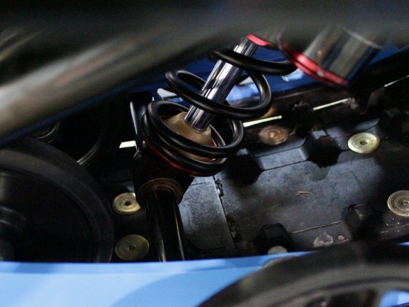 Install the stock sleeve through the bottom eye with the plastic spacer on both side of the eyelet.