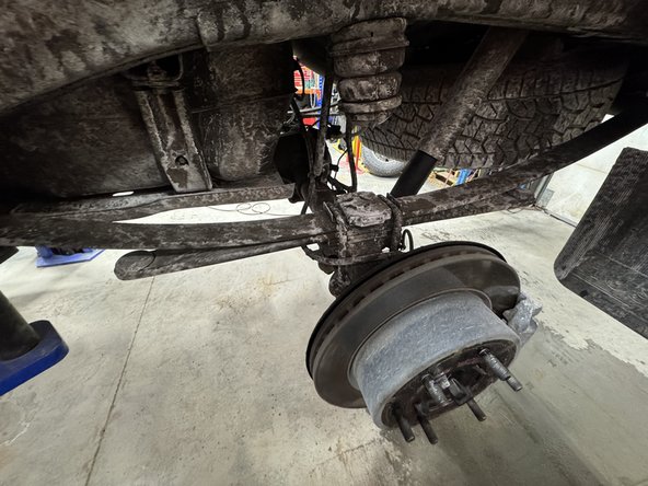 Remove upper and lower bolts from OEM shocks. Keep OEM bolts to install Elka shocks.