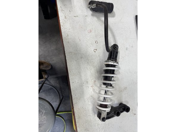 Remove the linkage from the OEM shock.