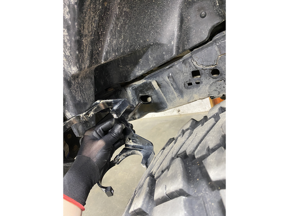 PASSENGER SIDE: Slide the small washer on the long 8mm bolt. Insert the bolt in the CENTER HOLE of the bracket assembly.