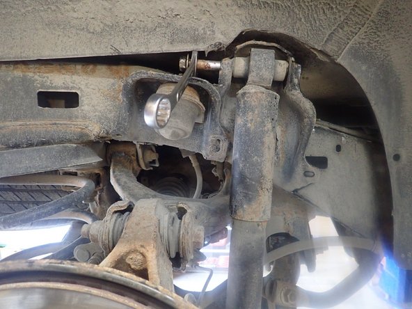 Remove upper and lower bolts and keep them to install Elka shocks.