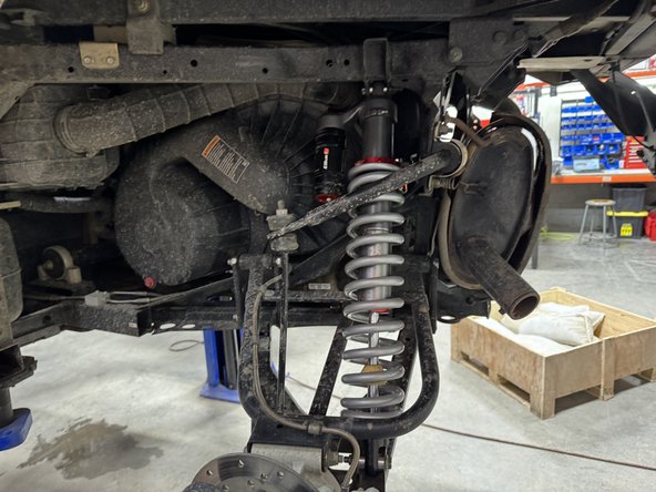 Install the new Elka rear shocks with the piggyback reservoir at the top and oriented towards the front of the vehicle.