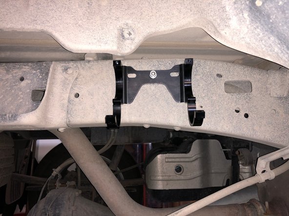 Install reservoir as shown into the holding clamps. Torque the bolts to 12 ft-lbs.