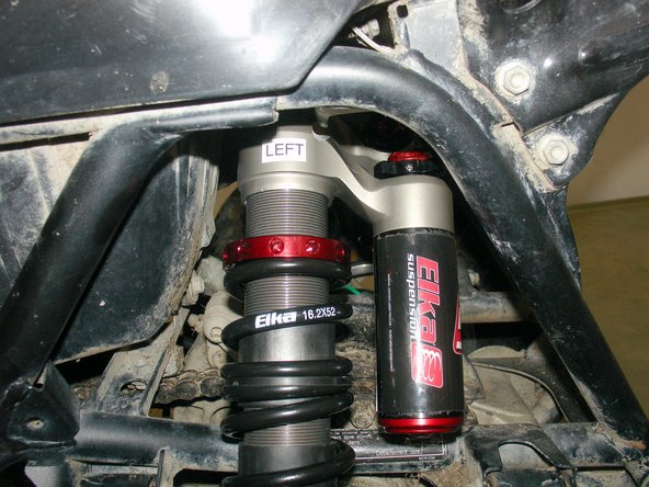 The piggyback reservoirs should be pointing towards the REAR of the vehicle, with the machined notches facing OUTSIDE the quad.