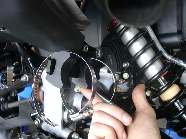 Insert first collar in the slot  shown by red Arrow. Install rubber mounts and second collar as shown.