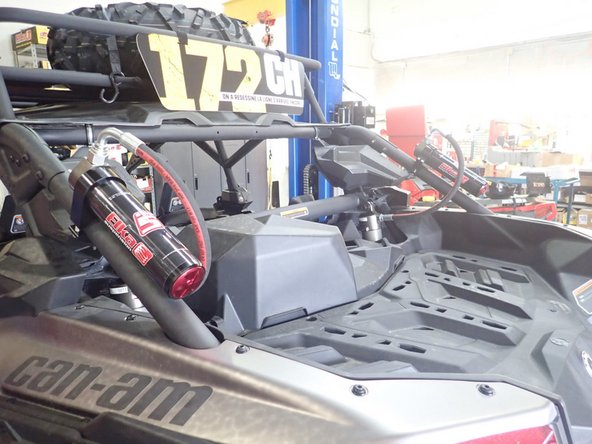 The reservoir is attache to the cage at the top with the hose facing upward.