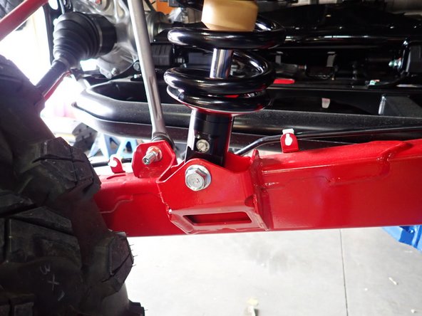 On Stage 2, Stage 4, and Stage 5 models the rebound adjuster located on lower eyelet of the shocks should be oriented towards the outside of the vehicle, as shown. (Right side shown ). If needed, you can turn the lower eyelet to orient properly.