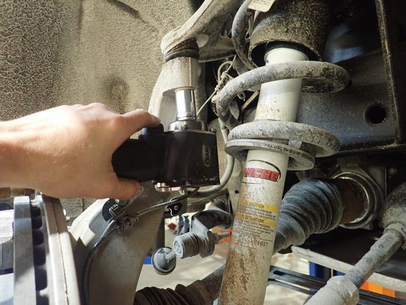 Separate upper control arms from steering knuckles.