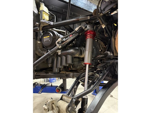 Note: The hose configurations differ between the left and right sides. Refer to the images to ensure the shocks are installed on the correct side.