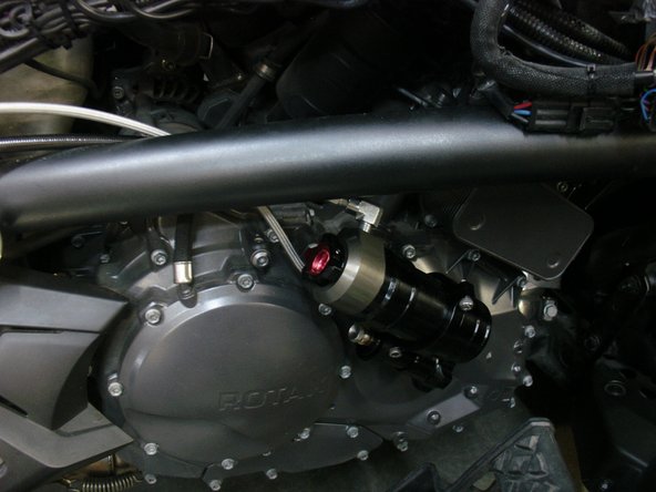 After fix the shock with OEM bolts, and torque them at manufacturer specs, pass the reservoir and the hydraulic preload adjuster behind the frame. The hoses must be routed as shown. You can use ty-wrap to secure them . DO NOT OVER BEND OR PINCH HOSES.