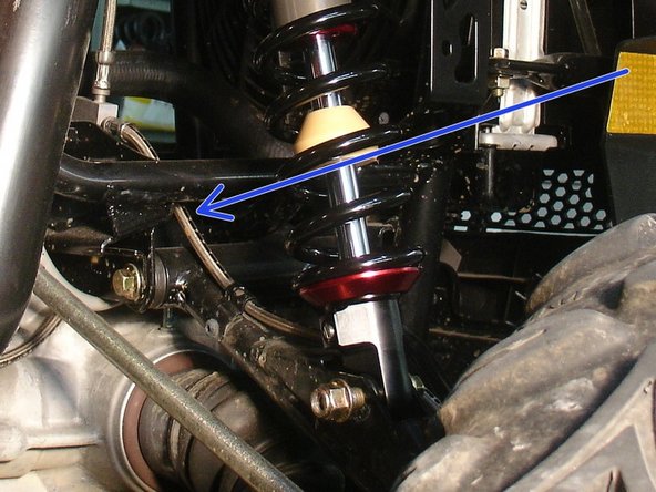 On Stage 2, Stage 4 and Stage 5 models, the lower shock eyelets should be installed with the rebound adjuster oriented towards the rear of the vehicle as shown by the blue Arrow on the photo ( right side shown ). If needed, you can turn the lower eyelet to orient properly.