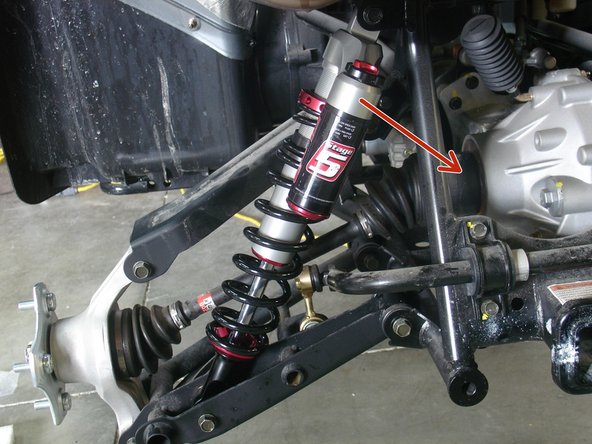 Install both new Elka rear shock with the piggyback reservoir at the top and oriented towards the rear of the vehicle as indicated by the red Arrow on the photo.