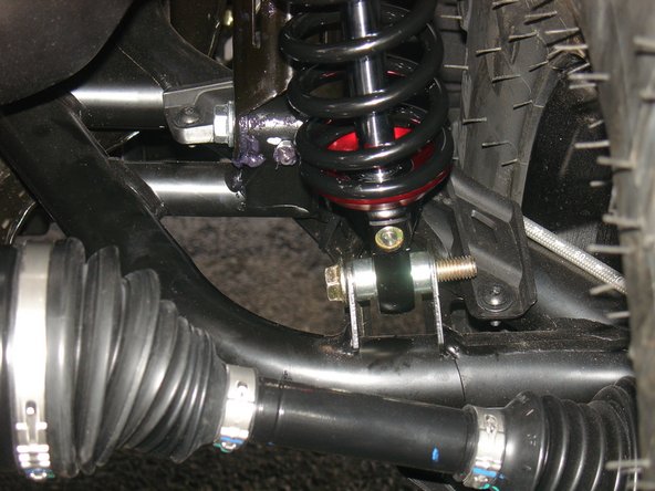 On Stage 2, Stage 4, and Stage 5 models the rebound adjuster located on lower eyelet of the shocks should be oriented towards the rear of the vehicle, as shown. (Right side shown ). If needed, you can turn the lower eyelet to orient properly.