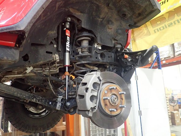 Place bracket to be parallel to frame, then torque nut at 50 ft/lb.