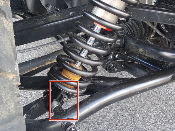 On Stage 2, Stage 4, and Stage 5 models the rebound adjuster located on lower eyelet of the shocks should be oriented towards the rear of the vehicle, as shown. (Shown by the red square ). If needed, you can turn the lower eyelet to orient properly.