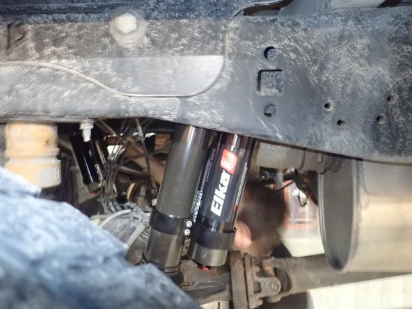 Slide head of rear right Elka shocks on upper stud making sure reservoir is facing the front of vehicle.