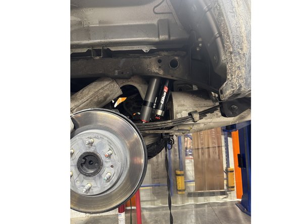 Install rear shock with the reservoir facing the front of the truck on the right side.