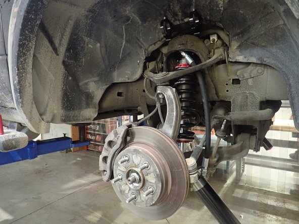 Fix reservoir's bracket by installing upper top plate bolts as shown.