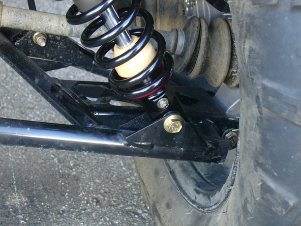 On Stage 2, Stage 4, and Stage 5 models the rebound adjuster located on lower eyelet of the shocks should be oriented towards the rear of the vehicle, as shown. (right side shown ). If needed, you can turn the lower eyelet to orient properly.