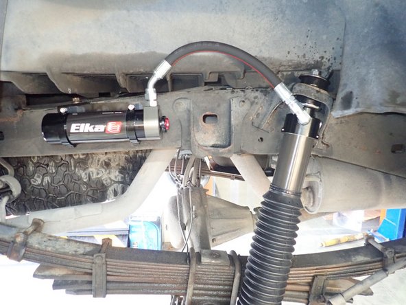 Tighten upper and lower shock bolts.