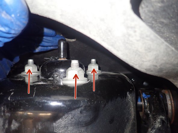 Remove the 3 upper shock nuts, except for the central nut.