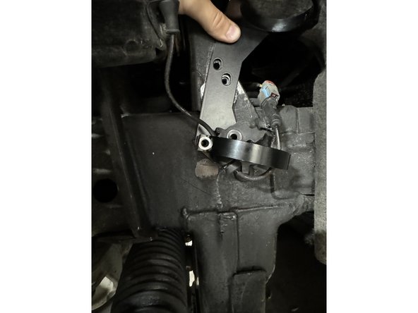 Insert the bended tab into the grommet and install the bracket as show in the picture. Make sure the bracket passes under the ABS line.