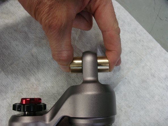 Install bushings with reduced diameter into o-rings, and hold them to put the shocks in place.
