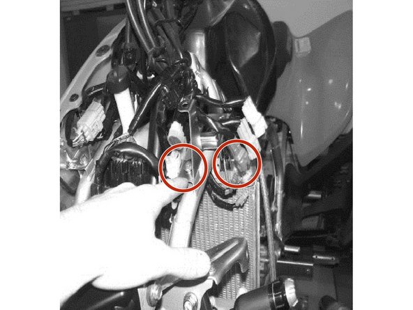 Remove the 2 bolts that holds the radiator mounting bracket on the left side.