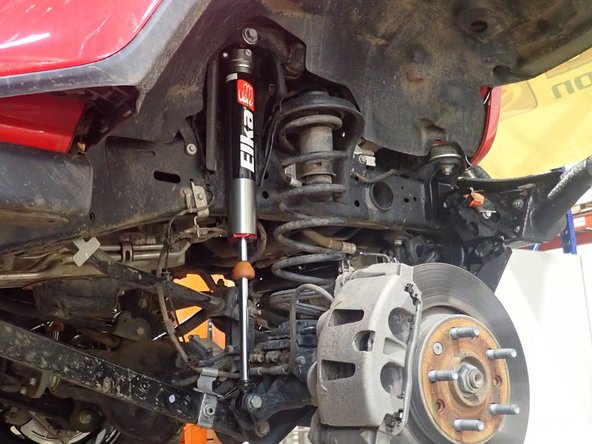 Place bracket to be parallel to frame, then torque nut at 50 ft/lb.